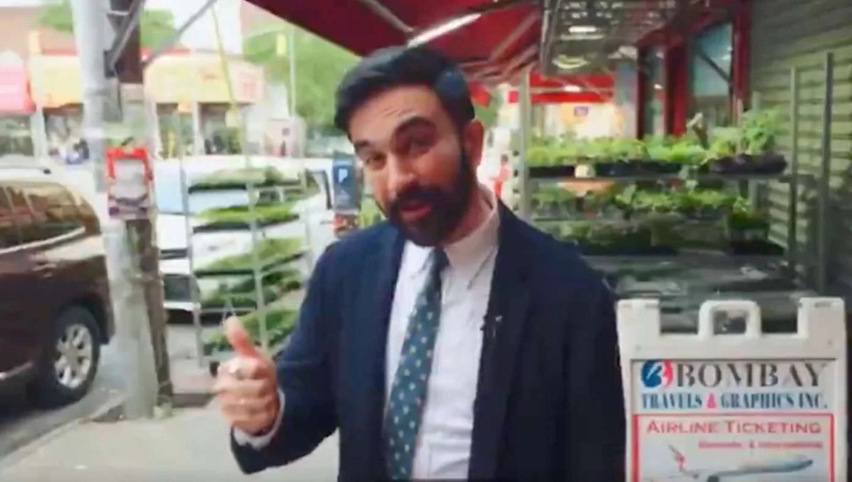 TruthScan detected a 21% chance this man in suit gesturing on a city street is AI-generated. Posted by @TheBabylonBee